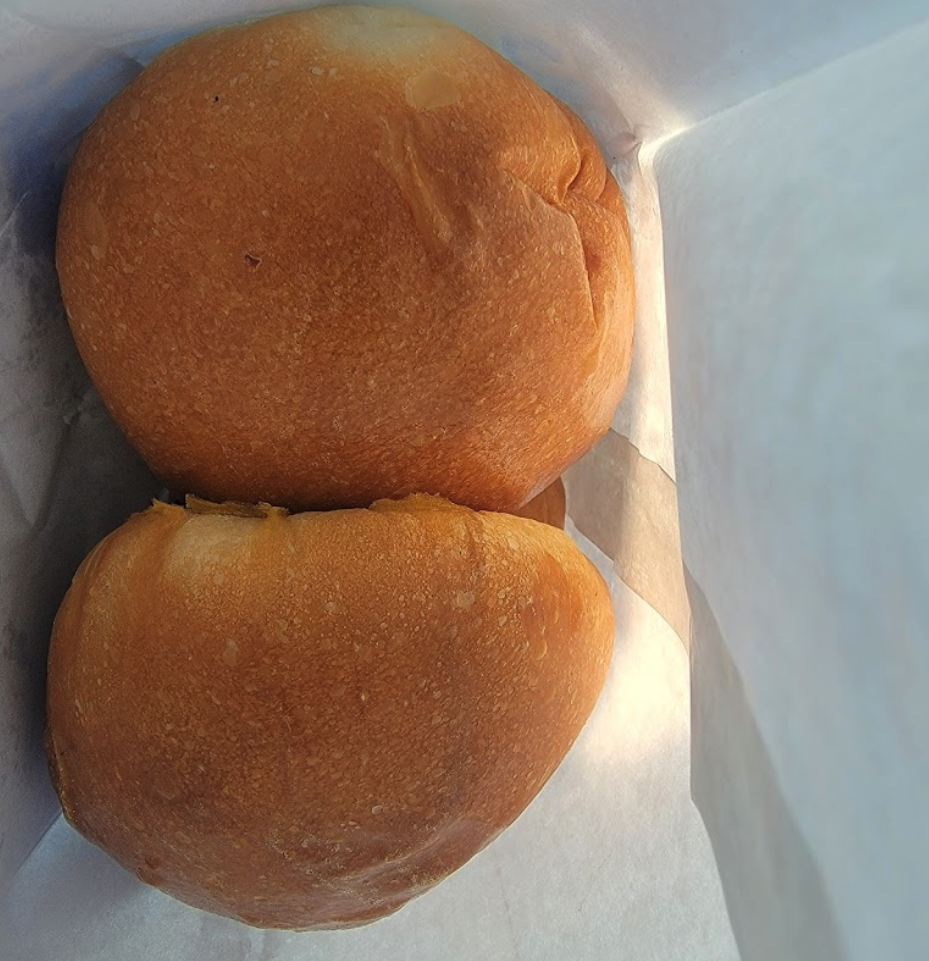 Freshly steamed BBQ pork buns in a takeout container